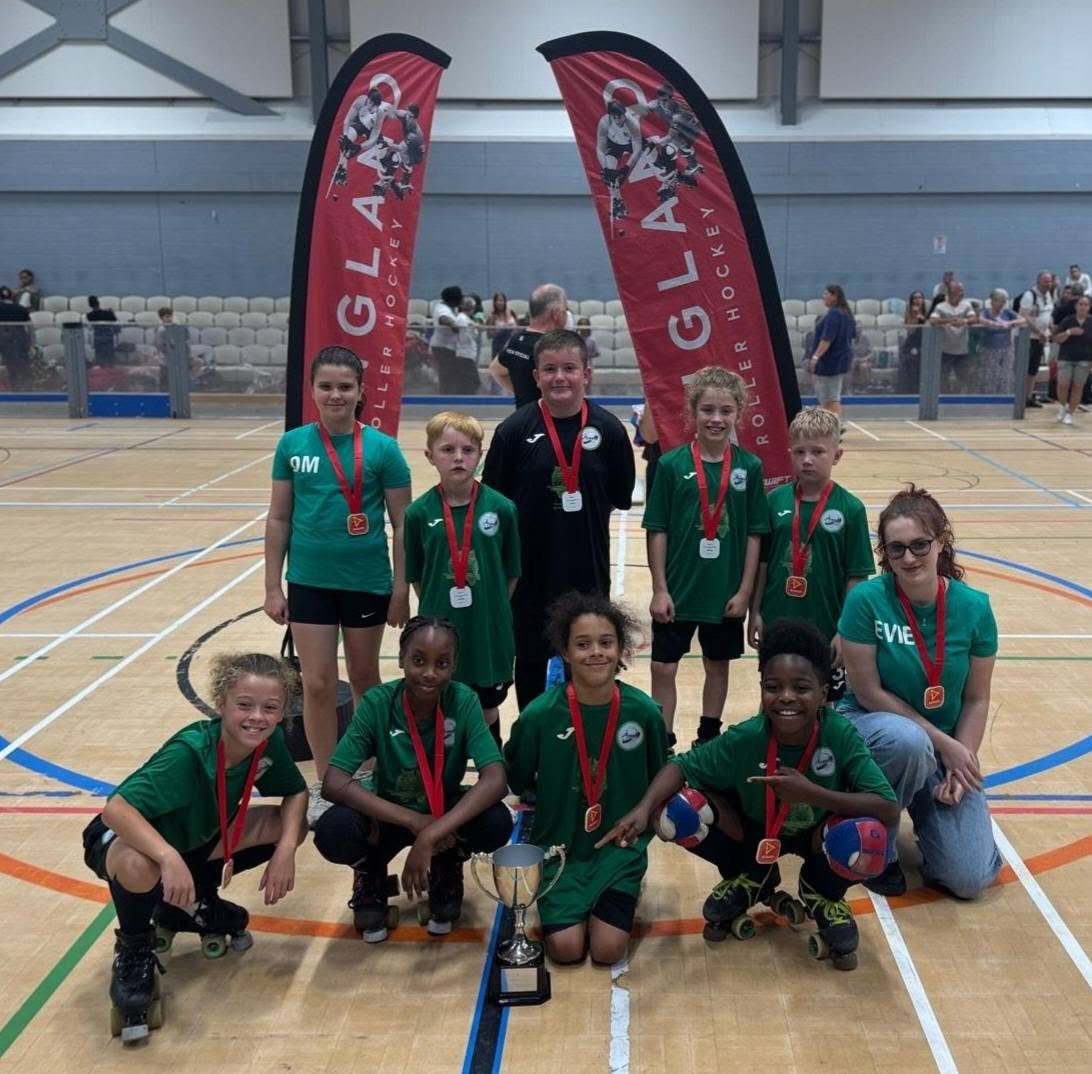 A junior squad with medals and a trophy after a final